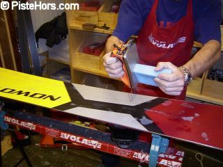 Applying wax to a snowboard